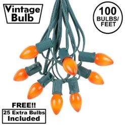 100 C7 String Light Set With Orange Ceramic Bulbs On Green Wire